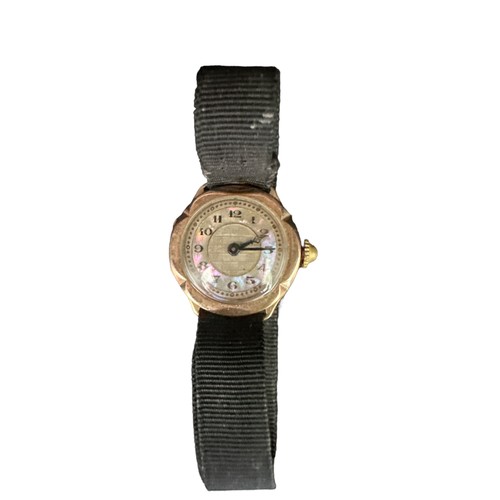 113 - A 9ct gold watch with a flower-shaped mother of pearl dial and black ribbon strap. Total weight 9.82... 