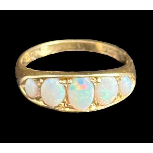 6 - A five stone opal ring, stamped 18ct. Opals show full spectrum of colour. Size M, weight 3.75g.
Plea... 