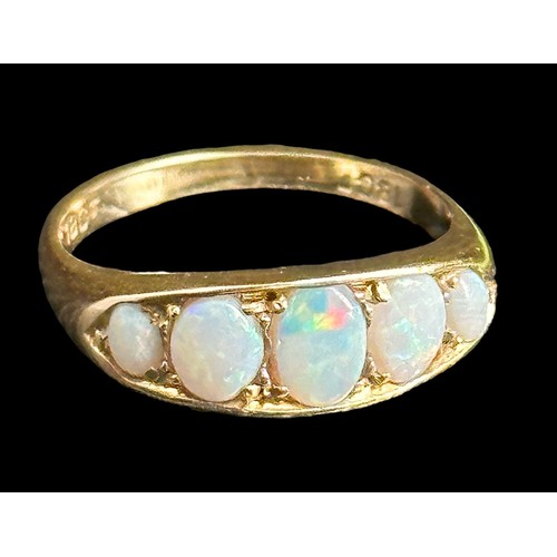 6 - A five stone opal ring, stamped 18ct. Opals show full spectrum of colour. Size M, weight 3.75g.
Plea... 