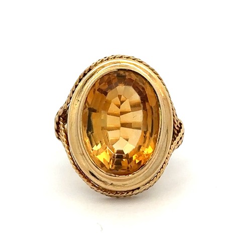 27 - A gold and citrine dress ring with rope twist surround. Size P. Citrine approx 16 x 12mm. Engraved 1... 