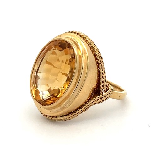 27 - A gold and citrine dress ring with rope twist surround. Size P. Citrine approx 16 x 12mm. Engraved 1... 