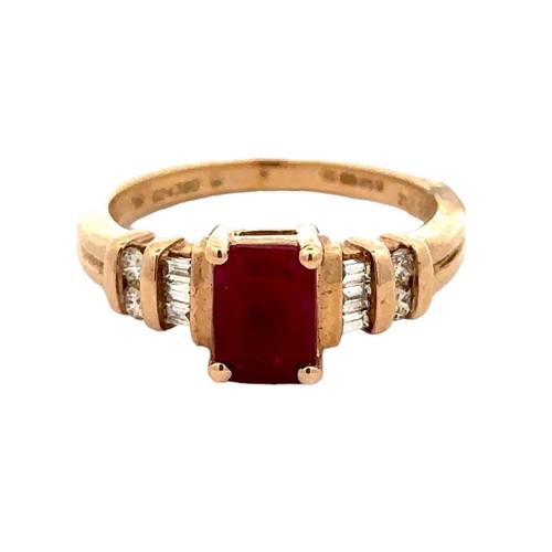 93 - A 9ct gold octagonal cut ruby and diamond ring. The treated ruby, approx 7mm x 5mm, is flanked on bo... 