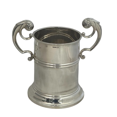 163 - A silver bottle holder with scroll handles by Walker & Hall. Hallmarks for Chester 1906. Height appr... 