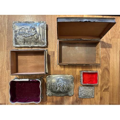 255 - Four white metal trinket boxes with embossed decoration. Some of the hinges are in need repair - ple... 