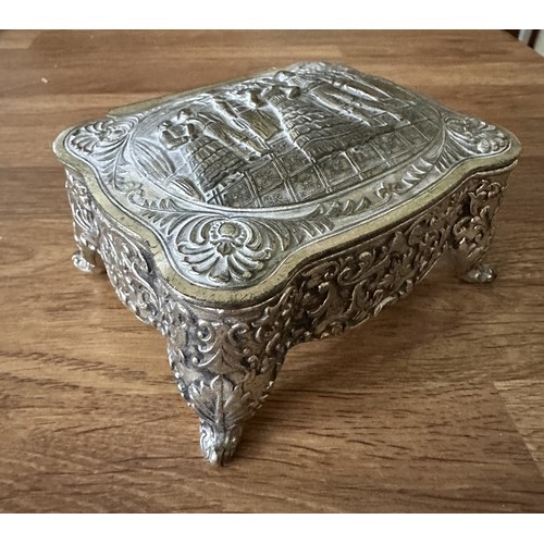 255 - Four white metal trinket boxes with embossed decoration. Some of the hinges are in need repair - ple... 