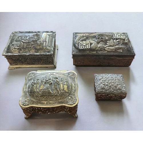 255 - Four white metal trinket boxes with embossed decoration. Some of the hinges are in need repair - ple... 