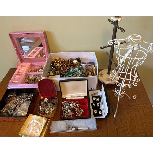 46 - A large amount of costume jewellery, a jewellery stand and wire dress display stand.
Please see the ... 