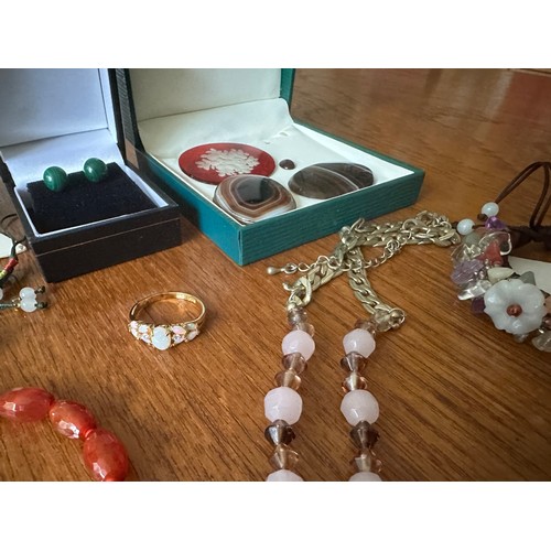 9 - A number of pieces of hardstone and gem set jewellery, including a jade Buddha pendant, a tagua nut ... 