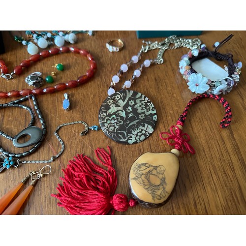 9 - A number of pieces of hardstone and gem set jewellery, including a jade Buddha pendant, a tagua nut ... 