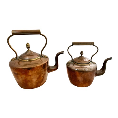 258 - Pair of Copper Kettles, two sized. Largest height 32cm, width 23cm. Smallest height 23cm, width 17cm... 