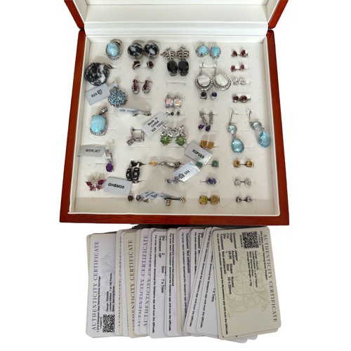 94 - A polished wooden Gemporia box containing sterling silver earrings and pendants, many still with the... 