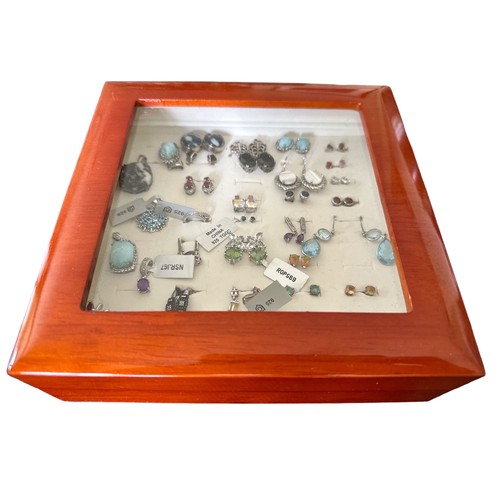 94 - A polished wooden Gemporia box containing sterling silver earrings and pendants, many still with the... 