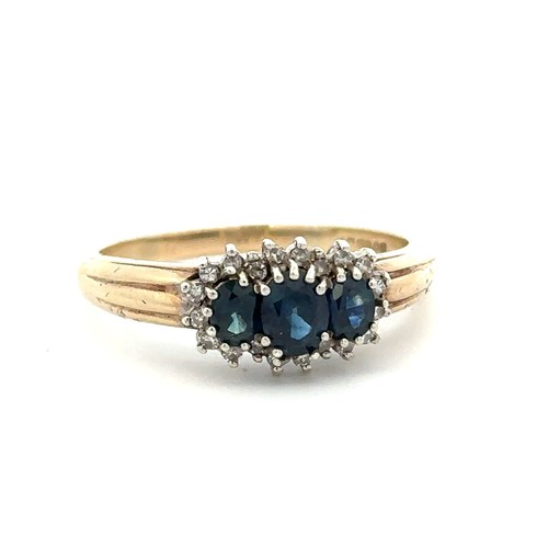 3 - A three stone sapphire and diamond cluster ring, set in 9ct yellow gold. London hallmarks. Size S/T.... 