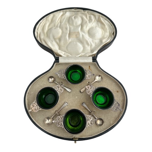 182 - A cased set of four sterling silver salts with green glass liners, together with four silver salt sp... 