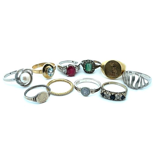 79 - Ten hallmarked silver or stamped 925 rings, including a ruby set ring and a topaz set ring.