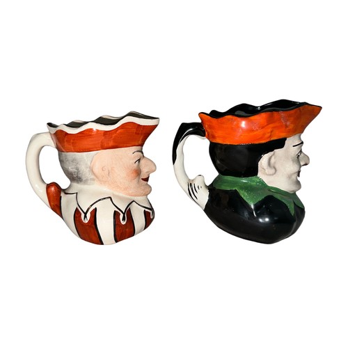 226 - Punch and Judy, pair of Punch & Judy hand painted ceramic jugs, two designs. Unmarked to base. Buyer... 