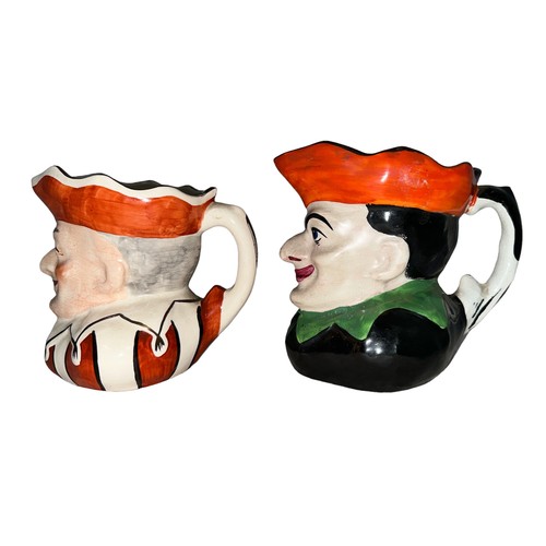 226 - Punch and Judy, pair of Punch & Judy hand painted ceramic jugs, two designs. Unmarked to base. Buyer... 