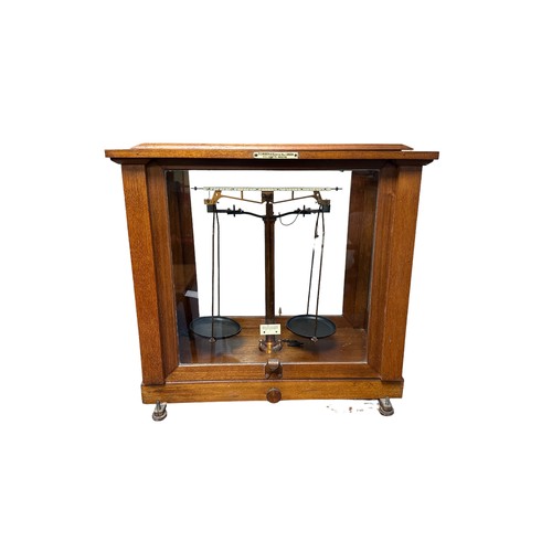 296 - F.E. BECKER & CO. Scientific beam balance with boxed weight in glazed display case.