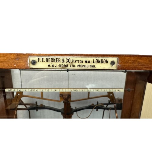 296 - F.E. BECKER & CO. Scientific beam balance with boxed weight in glazed display case.