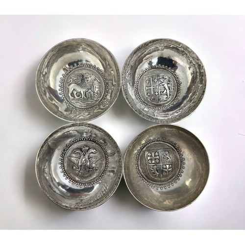 187 - Four continental white metal bowls stamped 800. Each with a different crest inside a beaded border.