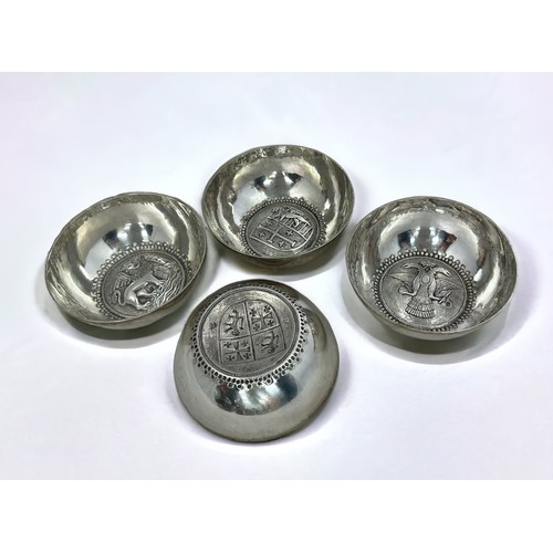 187 - Four continental white metal bowls stamped 800. Each with a different crest inside a beaded border.