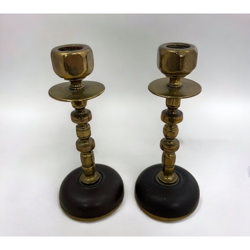 260 - A pair of brass candlesticks with a nuts and bolts design. Height 16cm.