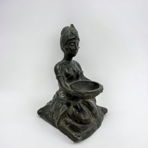 366 - A spelter statute of a kneeling woman holding a bowl.