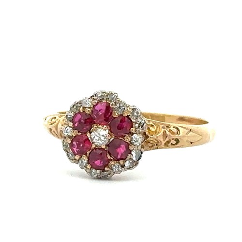 2 - A ruby and diamond flower ring with scroll shoulders,  stamped 18ct, size P. 3.02g.
Please see the b... 