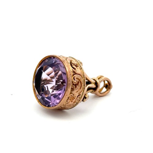 60 - A Victorian gold and amethyst fob. The round mixed cut amethyst of approx 15mm diameter is set in  a... 