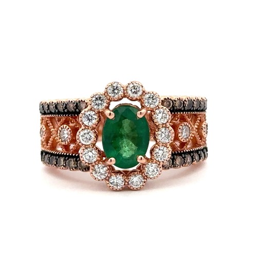 88 - An emerald and diamond rose gold cluster ring, size N.    Stamped 14K. Weight 6.88g. Oval emerald ap... 