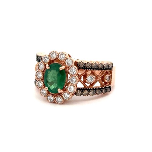 88 - An emerald and diamond rose gold cluster ring, size N.    Stamped 14K. Weight 6.88g. Oval emerald ap... 