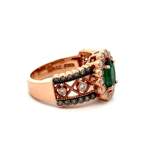 88 - An emerald and diamond rose gold cluster ring, size N.    Stamped 14K. Weight 6.88g. Oval emerald ap... 