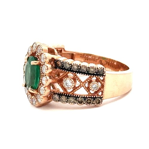 88 - An emerald and diamond rose gold cluster ring, size N.    Stamped 14K. Weight 6.88g. Oval emerald ap... 