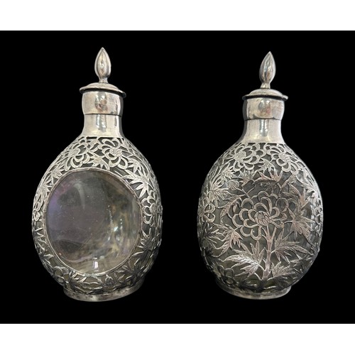 193 - A pair of oriental Japanese overlaid white metal and glass decanters with stoppers.  Each clear glas... 