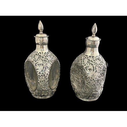 193 - A pair of oriental Japanese overlaid white metal and glass decanters with stoppers.  Each clear glas... 