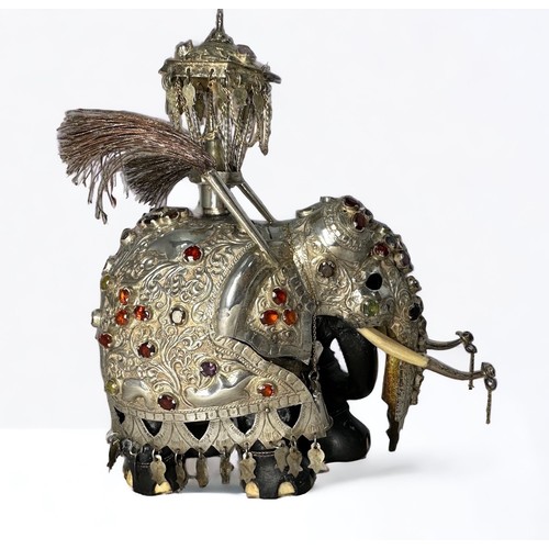 200 - A Sri Lankan silver and ebony Perahara elephant with howda.  Set with Ceylon gemstones and with bone... 