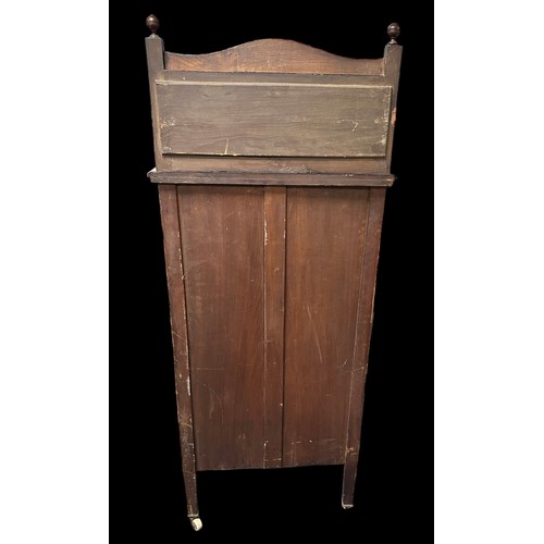 410 - Edwardian walnut music cabinet with mirror inset upstand, the partly glazed panelled door also with ... 