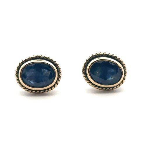 91 - A pair of  9ct gold and sapphire stud earrings with rope twist surround. Hallmarks on posts, butterf... 