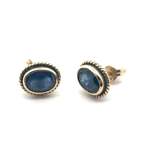 91 - A pair of  9ct gold and sapphire stud earrings with rope twist surround. Hallmarks on posts, butterf... 