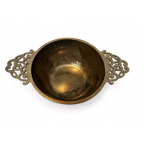 205 - A silver quaich style bowl with twin pierced handles. 10cm diameter, 16cm in length. S Blanckensee &... 