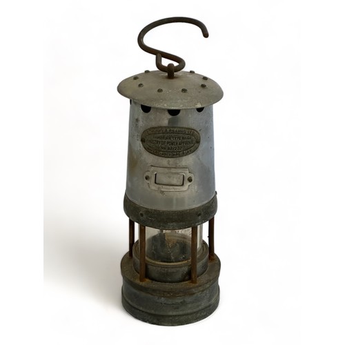 264 - A vintage miner's oil lamp with hanging hook by  E. Thomas & Williams. The attached plaque on the fr... 