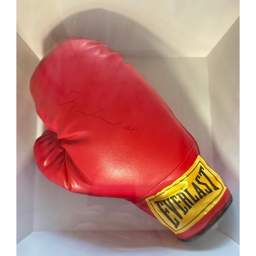 329 - A framed signed Muhammad Ali boxing glove. Muhammad Ali was an American professional boxer and activ... 