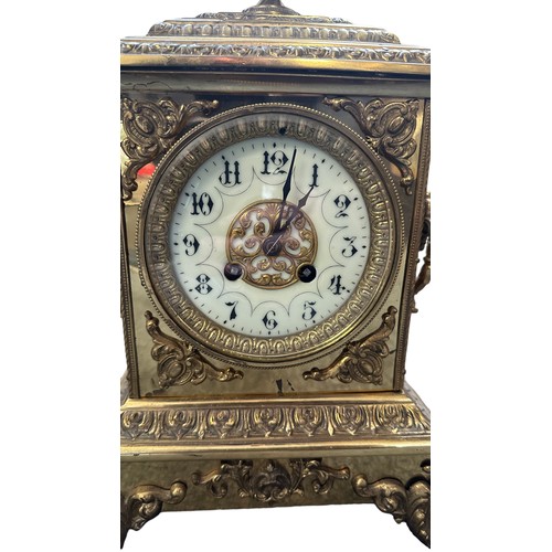 281 - A French ormolu style brass mantel clock with enamelled dial, height 40cm. In working order.