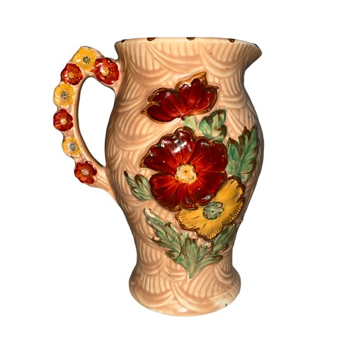 225 - An Arthur Wood jug with raised floral design. Height 20cm