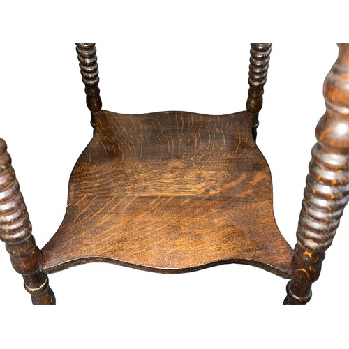 411 - Late 19th Century oak two-tier table, probably American, terminating on claw and glass ball feet. He... 