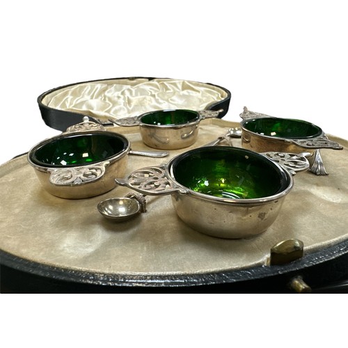 182 - A cased set of four sterling silver salts with green glass liners, together with four silver salt sp... 