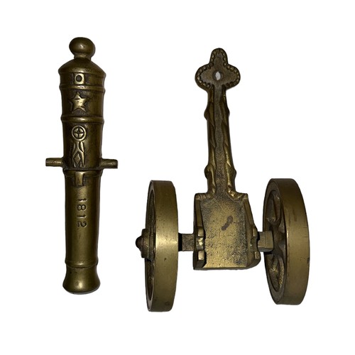 78 - Heavy brass decorative cannon, two pieces with working wheels, cannon inscribed ‘1812’. Length 28cm,... 