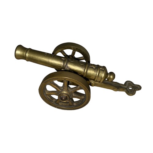 78 - Heavy brass decorative cannon, two pieces with working wheels, cannon inscribed ‘1812’. Length 28cm,... 