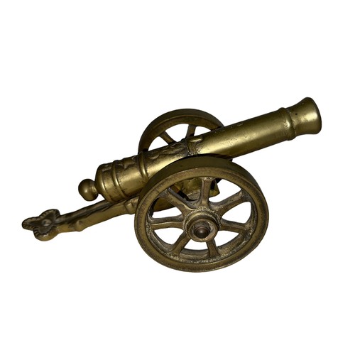 78 - Heavy brass decorative cannon, two pieces with working wheels, cannon inscribed ‘1812’. Length 28cm,... 