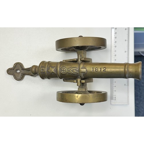 78 - Heavy brass decorative cannon, two pieces with working wheels, cannon inscribed ‘1812’. Length 28cm,... 